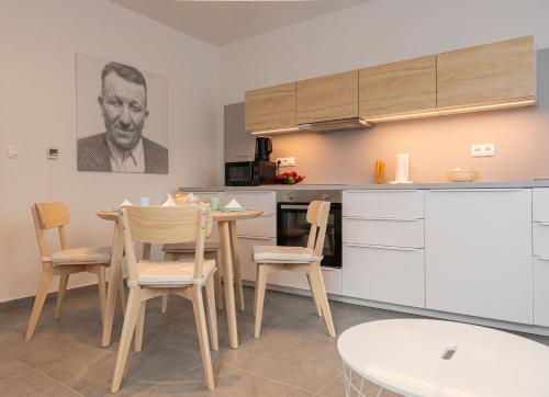 a kitchen with a table and chairs in a room at KOVÁCS Hosťovský dom Vendégház Guesthouse in Veľké Blahovo