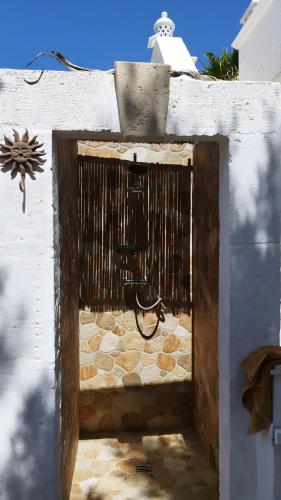 a gate in the side of a building with a stone floor at Villa Grace in Selva di Fasano