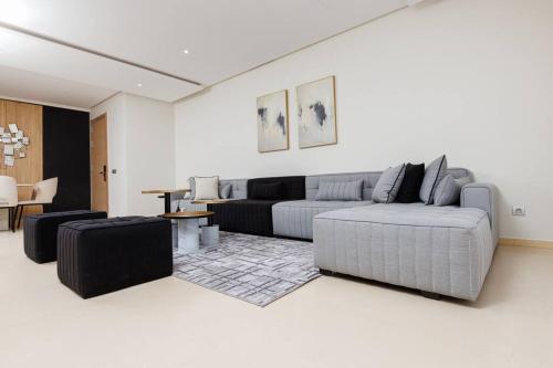 a living room with a couch and a table at Elegant 2BR in Hay Riad - New Furnishings & Design in Beni Brour