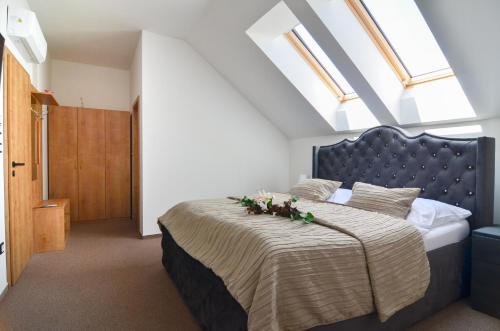 a bedroom with a large bed with flowers on it at Penzion Zaječák in Zaječí
