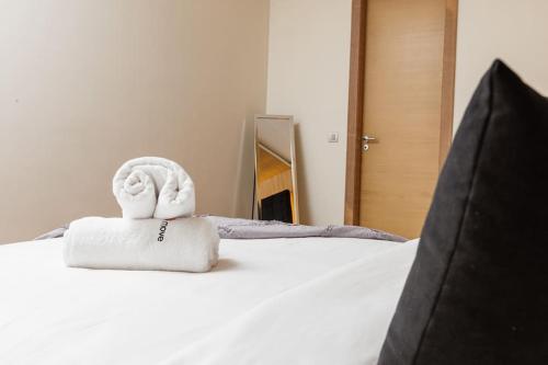 a towel animal sitting on top of a bed at Elegant 2BR in Hay Riad - New Furnishings & Design in Beni Brour
