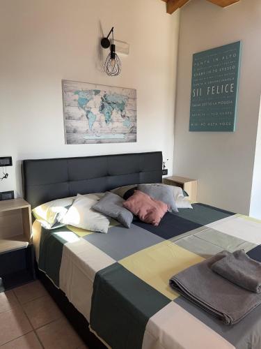 a man laying on a bed in a bedroom at Affittacamere PuntoZero in Scanzorosciate