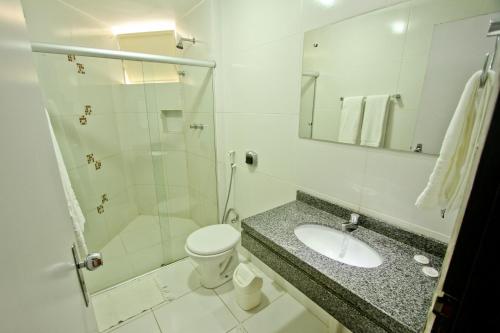 a bathroom with a toilet and a sink and a shower at Petrolina Palace Hotel in Petrolina