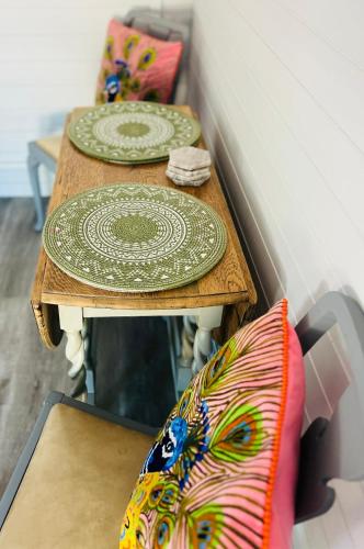 two wooden tables with plates on top of them at Lavender Lodge in Corfe Mullen