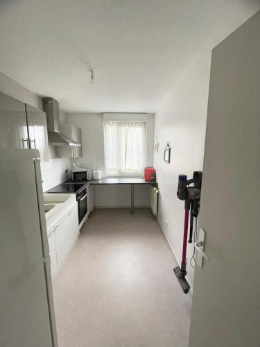 une cuisine vide avec un évier et une fenêtre dans l'établissement Grand T2 spacieux très calme, à Bron