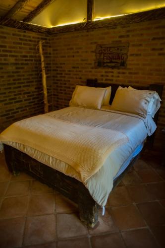 Una cama o camas en una habitación de Refugio Natural Guarne
