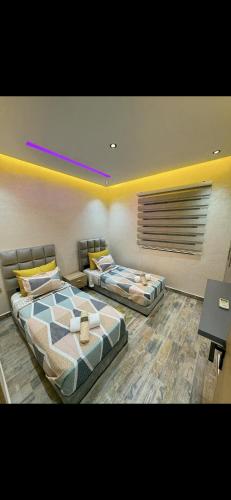 two beds sitting in a room with at Super appartement proche de l aéroport in Bou-Okkaz