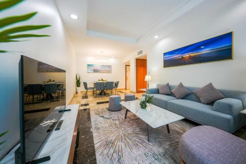 a living room with a couch and a table at Al Bustan Centre & Residence in Dubai