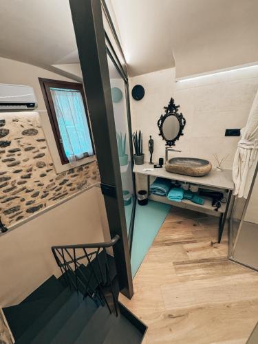 a small bathroom with a sink and a mirror at Talking Stones in Dolceacqua