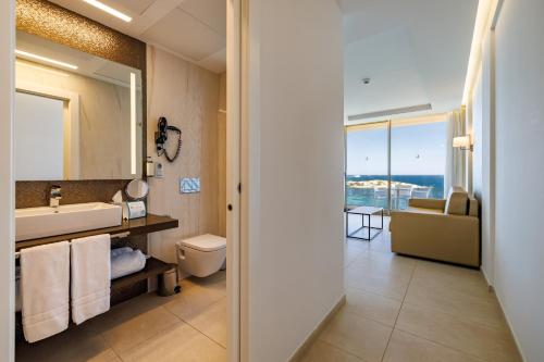 a bathroom with a sink and a mirror at Hotel Torre del Mar - Ibiza in Playa d'en Bossa