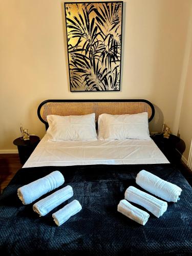 a bed with three pillows on top of it at Jungle House - Nuvola Lavazza in Turin
