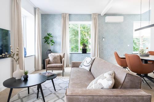 a living room with a couch and a table at Newly Renovated XL home city center in Nijmegen