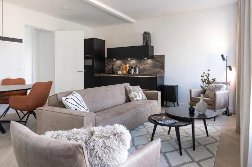 a living room with a couch and a table at Newly Renovated XL home city center in Nijmegen