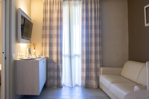 a living room with a couch and a window at Hotel Degli Ulivi in Ferrandina