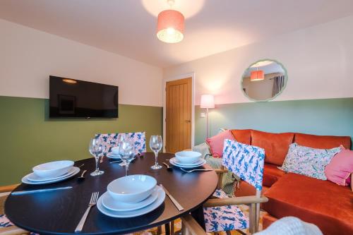 a living room with a table and a couch at Practical 2 Bedroom House Perfect for Contractors in Grimsby by PureStay - 7 night min! in Grimsby
