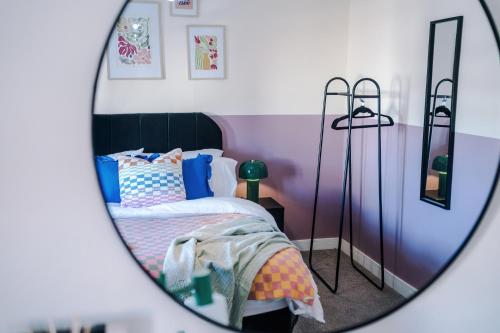 a bedroom with a bed and a mirror at Practical 2 Bedroom House Perfect for Contractors in Grimsby by PureStay - 7 night min! in Grimsby
