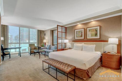 a large hotel room with a bed and a desk at MGM Signature-03-703 Strip View Jacuzzi Studio in Las Vegas
