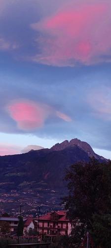 a sunset over a city with a mountain in the background at Marlingsuites - Vinea - Wieser Josef - Marling in Marlengo