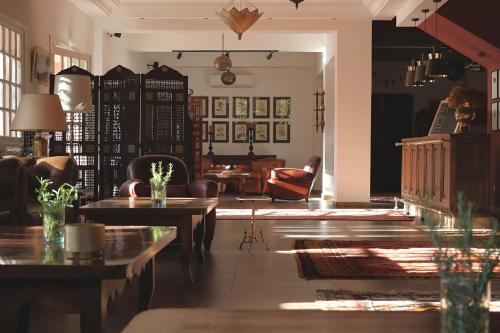 a living room with tables and chairs and a couch at Domaine de la Roseraie Resort in Ouirgane