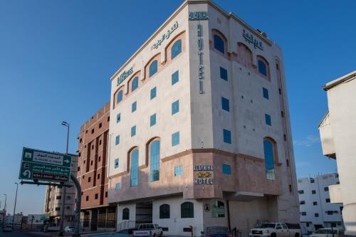 a tall building on the corner of a street at Al Ayniah Hotel in Al Madinah