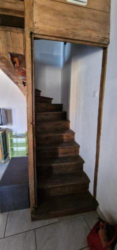 a staircase in a room with a wooden stair case at Chambres d'Hôtes Chez Jean in Spoy