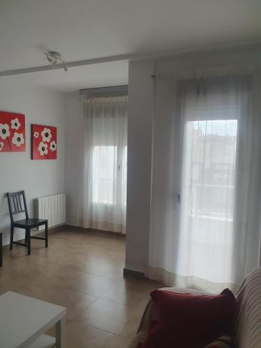 a living room with a couch and a window at PISO CENTRICO CON GARAJE en Hellin in Hellín