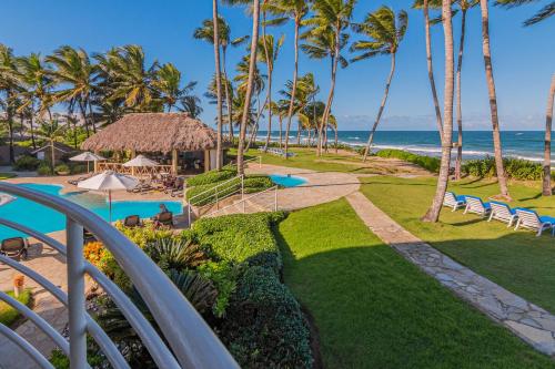 a view of the beach from the balcony of a resort at Truly Beachfront at Quiet Beach in Cabarete