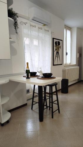 a white table with two bowls on it in a kitchen at Braguti Apartments in Romano di Lombardia