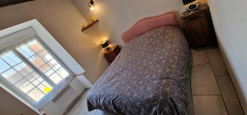 an overhead view of a bed in a room with a window at Chambres d'Hôtes Chez Jean in Spoy