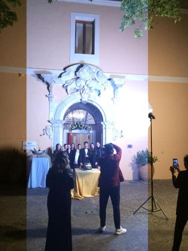 a group of people standing in front of a table at VillaGrancassa Hotel Relais in San Donato Val di Comino
