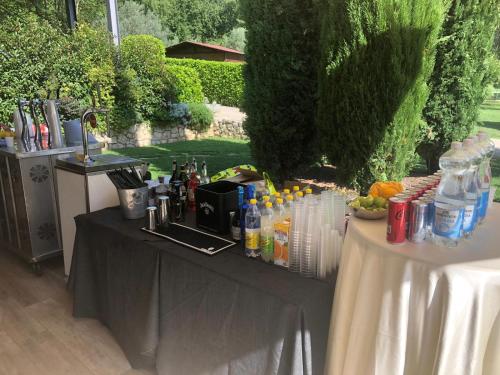 a table set up for a party with drinks on it at VillaGrancassa Hotel Relais in San Donato Val di Comino