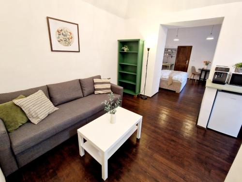 a living room with a couch and a table at Helena Old Town Apartment in Košice