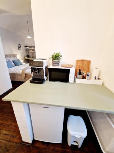 a kitchen with a counter top with a microwave at Helena Old Town Apartment in Košice