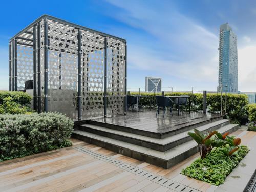 a garden with a gazebo on the roof of a building at Star KLCC Elegant 2-3pax by DingDing in Kuala Lumpur
