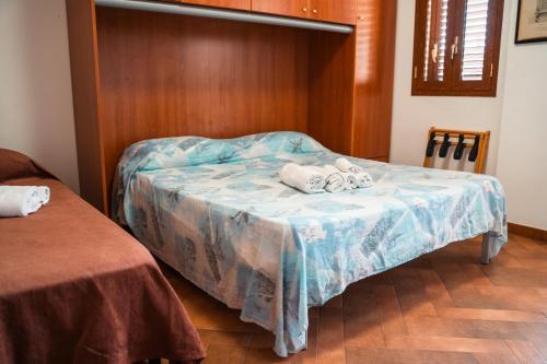 a bedroom with a bed with towels on it at Taormina Beach Front - Mazzeo in Mazzeo