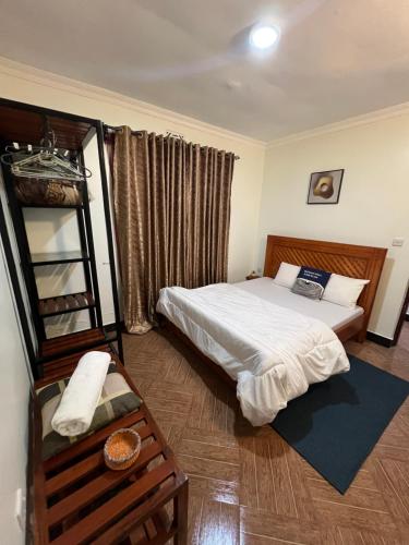 a bedroom with a bed and a ladder in it at Lavish luxury homes in Nkoanrua