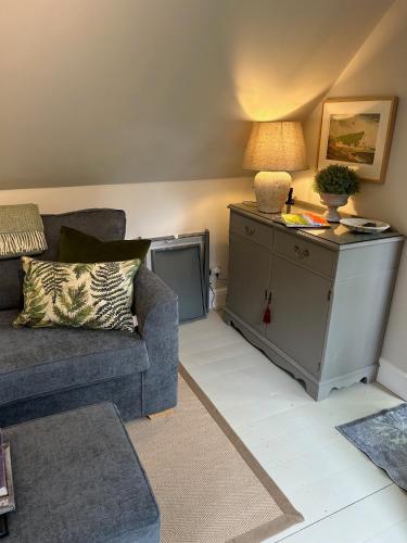 a living room with a couch and a table at Idyllic rural retreat in Plumpton Green