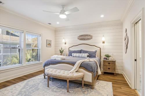 a bedroom with a bed and a chair and a window at 3 Shore Crest Lane- Chefs Kitchen, Game Room, Near Beach, Private Pool, FREE Activities Included in Hilton Head Island