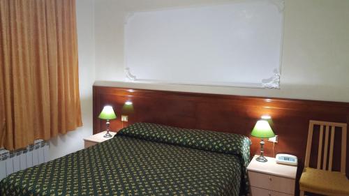 Ένα ή περισσότερα κρεβάτια σε δωμάτιο στο Hotel Rosetta
