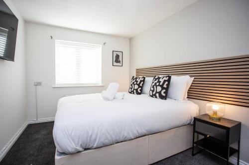 a bedroom with a large white bed and a window at Arkless Grove Free Parking Wifi in Black Hill