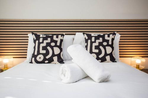 a white bed with two pillows and two towels at Arkless Grove Free Parking Wifi in Black Hill