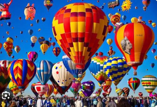 a bunch of hot air balloons in the sky at Hot Air Balloon Haven, Hot Tub, King Bed, Office, Foosball, Bball in Albuquerque