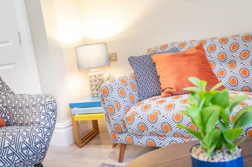 a living room with a couch and a chair at 5 Star - The Ulsterville Residences - Free On-site Parking in Belfast