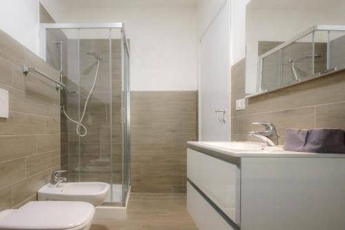 a bathroom with a shower and a toilet and a sink at Airport Bari palese LUXURY 2 in Bari