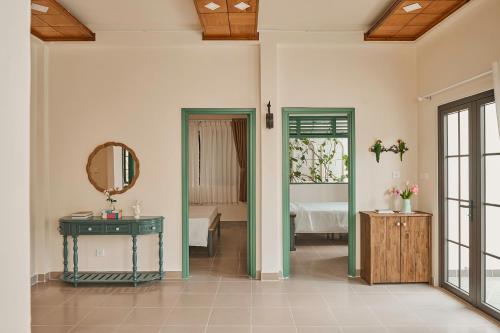 a room with a bed and a mirror and a table at Casa Villa - charming symphony in Dalat center in Da Lat