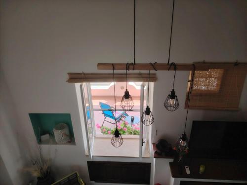a room with a window with two hanging lights at Villa la Milanina in Lipari