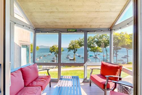 a living room with a view of the water at Lakefront At Winnipesaukee in Gilford