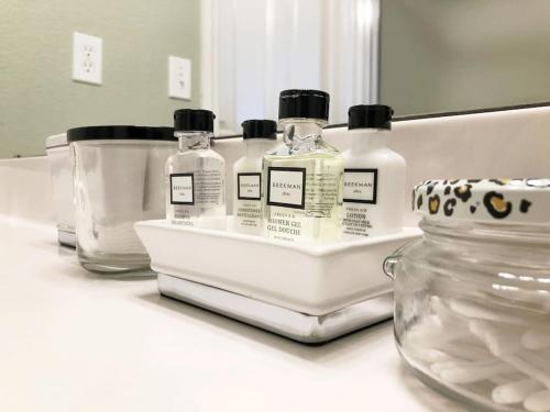 three bottles of soap and a jar on a counter at McKinley House - Gym, Garage and Fenced Yard in Amarillo