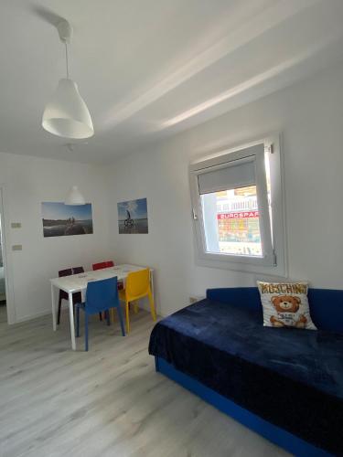 a bedroom with a bed and a table with chairs at Appart-Hotel Holiday in Lignano Sabbiadoro