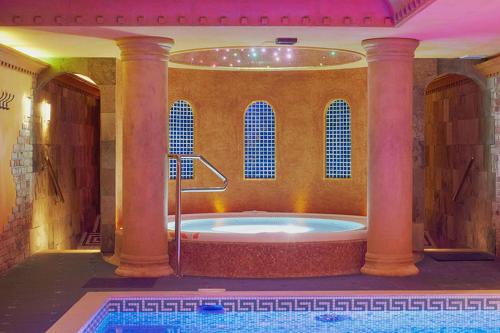 a large bathroom with a tub in a room with at Privilege - EMPIRE Hotels Group in Košice